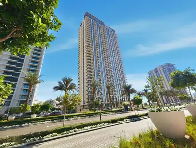 a tall building on a street with palm trees at Serene Creek Harbour Escape with Burj Khalifa View in Dubai