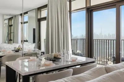 a dining room with tables and chairs and large windows at Serene Creek Harbour Escape with Burj Khalifa View in Dubai