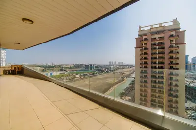a balcony with a view of a tall building at Settler Homes - Premium Matrix Tower with Hot Tub in Dubai