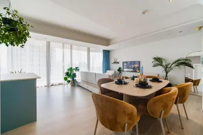 a dining room and living room with a table and chairs at Settler Homes - Premium Matrix Tower with Hot Tub in Dubai