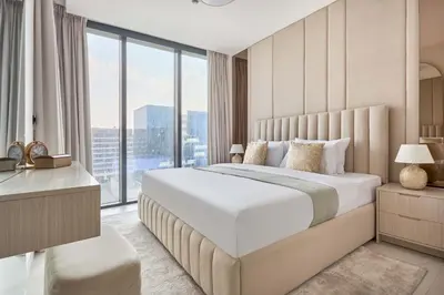 a bedroom with a large bed with a large window at Frank Porter - The Crest Tower, Sobha Hartland in Dubai