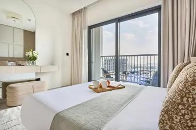 a hotel room with a bed and a large window at Frank Porter - The Crest Tower, Sobha Hartland in Dubai