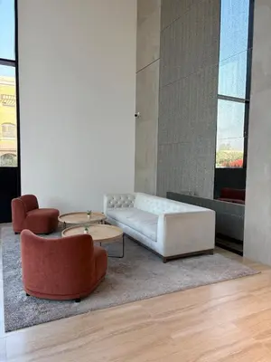 a living room with a white couch and two chairs at Lux 2 Bedroom Cozy Family Getaway Home in Dubai
