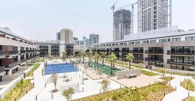 an aerial view of a building with a pool at Lux 2 Bedroom Cozy Family Getaway Home in Dubai