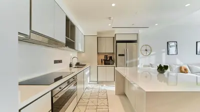 a white kitchen with a large white counter top at Prime 3BR Maid Sunrise Bay Ain Dubai Palm View in Dubai