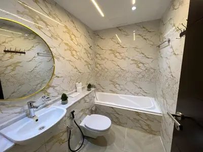 a bathroom with a sink toilet and a mirror at Luxurious full renovated apartment in Dubai