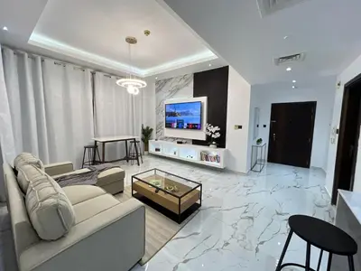a living room with a couch and a tv at Luxurious full renovated apartment in Dubai