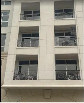 a tall white building with windows and balconies at Luxurious full renovated apartment in Dubai