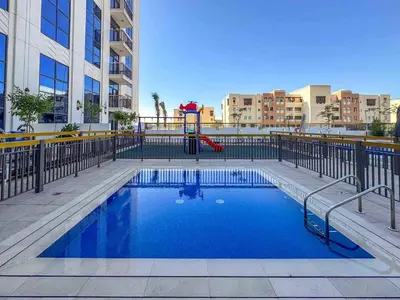 a swimming pool with a playground in a city at Frank Porter - Avenue Residence in Dubai