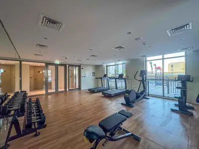 a gym with chairs and exercise equipment in a building at Frank Porter - Avenue Residence in Dubai