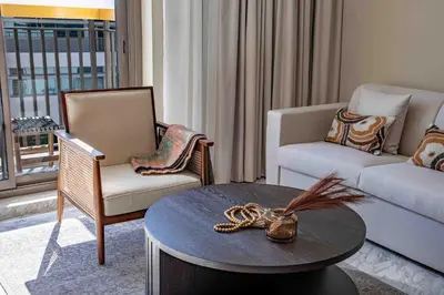 a living room with a table and two chairs and a couch at Frank Porter - Avenue Residence in Dubai