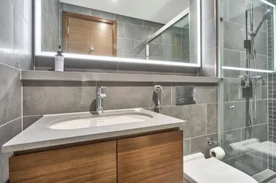 a bathroom with a sink and a mirror at STAY BY LATINEM Luxury 1BR Holiday Home CB 3814 Near Burj Khalifa in Dubai