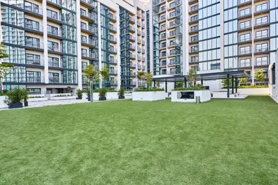 a large yard in front of a large apartment building at STAY BY LATINEM Luxury 1BR Holiday Home CB 3814 Near Burj Khalifa in Dubai