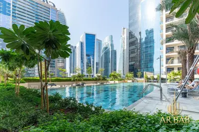 a swimming pool in a city with tall buildings at Arbab Homes Luxury 1BR - Canal View - Damac Zada Tower in Dubai