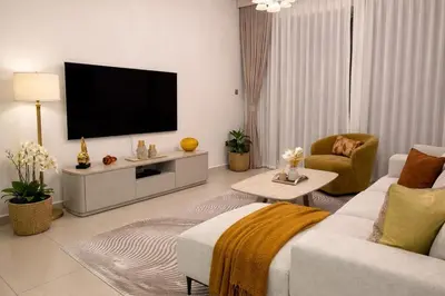 a living room with a flat screen tv on a wall at Modern 1-BR in Armada Tower 3, JLT, Sky Views in Dubai