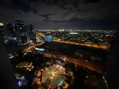 a view of a city at night with a ferris wheel at Modern 1-BR in Armada Tower 3, JLT, Sky Views in Dubai