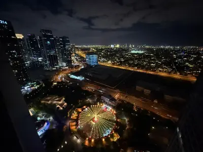 a night view of a city with a ferris wheel at Modern 1-BR in Armada Tower 3, JLT, Sky Views in Dubai