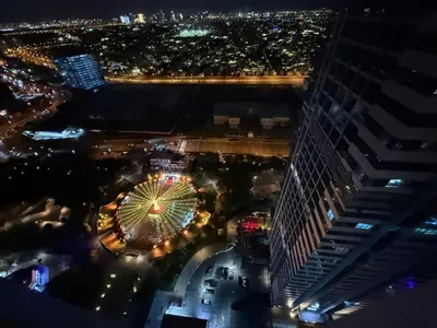 an aerial view of a ferris wheel at night at Modern 1-BR in Armada Tower 3, JLT, Sky Views in Dubai