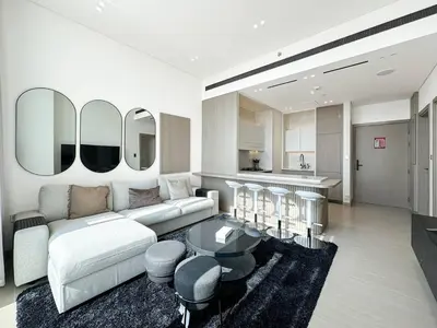 a living room with a couch and a table at Modern and Cozy 1 Bedroom with Private Balcony Pool in Dubai