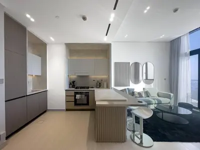 a kitchen and living room with a table and a couch at High-End Living With Private Pool in Dubai