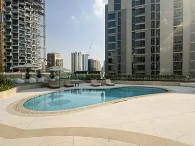 a swimming pool in the middle of a city with tall buildings at High-End Living With Private Pool in Dubai