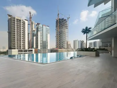 a swimming pool in the middle of a city with tall buildings at High-End Living With Private Pool in Dubai