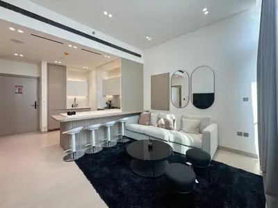 a living room with a couch and a table at High-End Living With Private Pool in Dubai