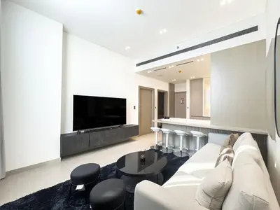 a living room with a white couch and a table at High-End Living With Private Pool in Dubai