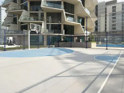 a basketball court in front of a building at Modern and Cozy 1 Bedroom with Private Balcony Pool in Dubai