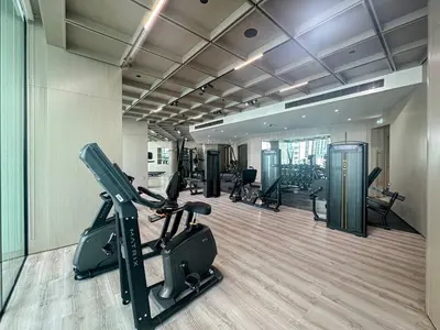 a gym with treadmills and ellipticals in a room at Modern and Cozy 1 Bedroom with Private Balcony Pool in Dubai