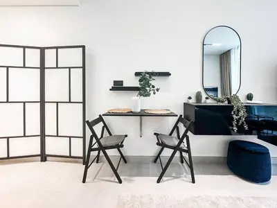 a room with two chairs and a vanity with a mirror at Modern Studio with Private Jacuzzi in Dubai
