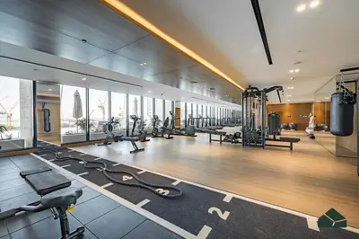 a gym with treadmills and exercise equipment in a building at Modern Studio with Private Jacuzzi in Dubai