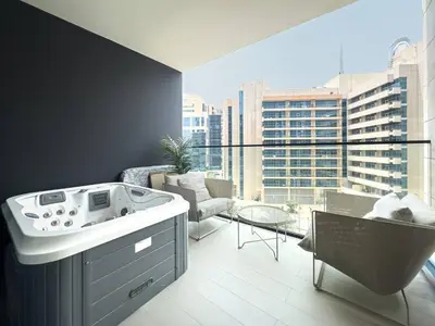 a bath tub in a room with a large window at Modern Studio with Private Jacuzzi in Dubai