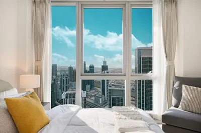a bedroom with a large window with a view of a city at Mahogany 24 - 2BR 6 PAX - On the Boulevard Sea View in Dubai