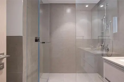 a shower with a glass door in a bathroom at Mahogany 24 - 2BR 6 PAX - On the Boulevard Sea View in Dubai