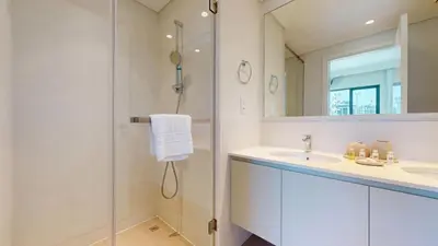 a bathroom with a shower and a sink and a mirror at Vacationer l Upgraded Aesthetic 2 Bed l near Dubai Hills Mall in Dubai