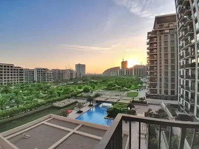 a view of a city with a pool and buildings at Vacationer l Upgraded Aesthetic 2 Bed l near Dubai Hills Mall in Dubai