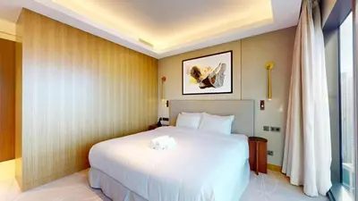 a bedroom with a large white bed and a window at Vacationer l Elegant 2 Bed l near Burj Khalifa l Address Opera in Dubai