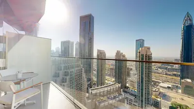 a person standing on a balcony with a view of a city at Vacationer l Elegant 2 Bed l near Burj Khalifa l Address Opera in Dubai