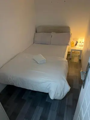 a large white bed in a small room at Quiet Comfort Room In Barsha Heights Tecom in Dubai
