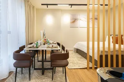 a room with a table with chairs and a bed at Luxe 4BR Upscale Beach Side Unit with Pool Table in Dubai