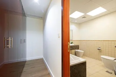 a bathroom with a tub and a toilet and a sink at Luxe 4BR Upscale Beach Side Unit with Pool Table in Dubai
