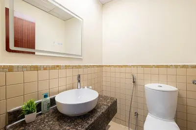a bathroom with a white sink and a mirror at Luxe 4BR Upscale Beach Side Unit with Pool Table in Dubai