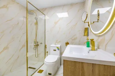 a bathroom with a toilet and a sink and a shower at Lux condo 3 BHK in Dubai Marina in Dubai