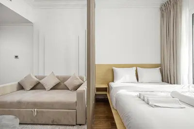 a bedroom with two beds and a couch at Luxury 3BHK with floating bed in Marina in Dubai