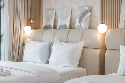 a hotel room with a bed with white pillows at Luxury 3BHK with floating bed in Marina in Dubai