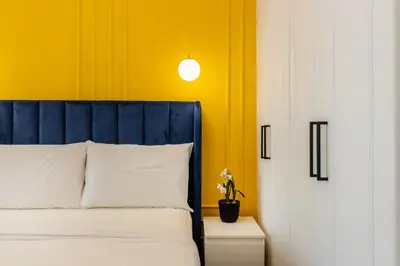 a bedroom with a bed and a yellow wall at Luxury 3BR & Floating Bed in Marina with Pool in Dubai