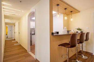 a kitchen with a bar and chairs in a hallway at Luxury 3BR & Floating Bed in Marina with Pool in Dubai
