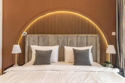 a bedroom with a large bed with a large headboard at Luxury 3BR & Floating Bed in Marina with Pool in Dubai