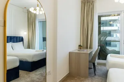 a hotel room with a bed and a mirror at Luxury 3BR & Floating Bed in Marina with Pool in Dubai
